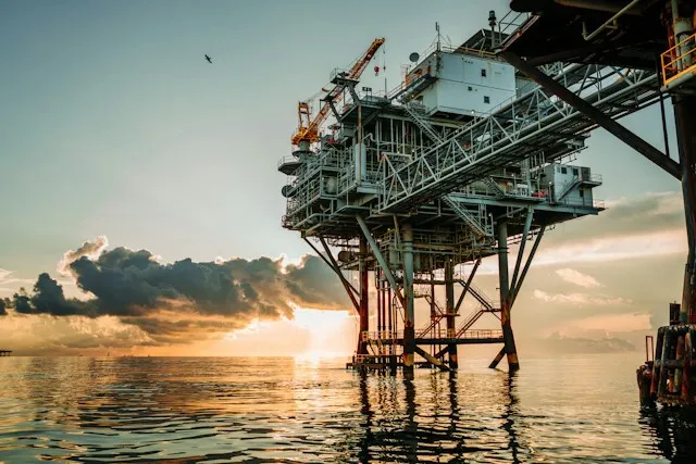 Offshore production platform at sunset on a calm sea